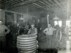 Five unidentified employees on the factory floor at the Mansfield Tire and Rubber Company.